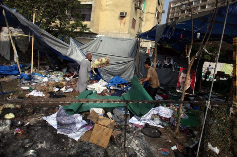 Egyptians collect items left in damaged tents outside Rabaah al-Adawiya mosque, where supporters of Egypt's ousted President Mohammed Morsi had a protest camp in Nasr City, Cairo, Egypt, Thursday, Aug. 15, 2013. Egypt faced a new phase of uncertainty on Thursday after the bloodiest day since its Arab Spring began, with hundreds of people reported killed and thousands injured as police smashed two protest camps of supporters of the deposed Islamist president. Wednesday's raids touched off day-long street violence that prompted the military-backed interim leaders to impose a state of emergency and curfew, and drew widespread condemnation from the Muslim world and the West, including the United States. (AP Photo/Khalil Hamra)