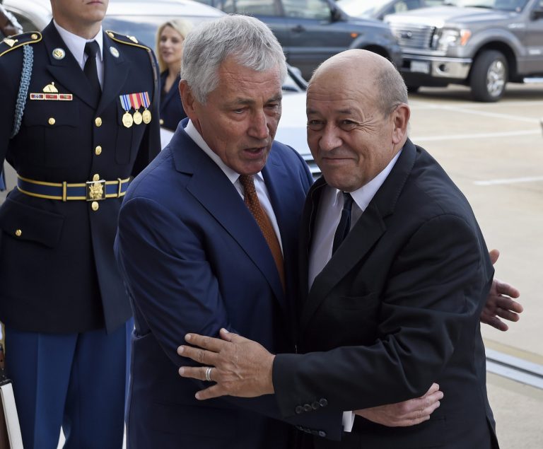 Defense Secretary Chuck Hagel greets French Defense Minister Jean-Yves Le Drian as he arrive for an honor cordon at the Pentagon, Thursday, Oct. 2, 2014. (AP Photo/Susan Walsh)