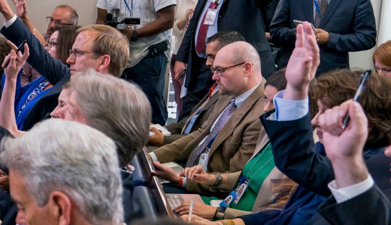 New York Times reporter Glenn Thrush, center, will stay suspended until the end of Jan. 2018 after several women accused him of sexually inappropriate behavior. (AP Photo/Andrew Harnik)