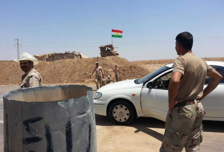 Kurdish security forces prepare combat positions while a Kurdish flag flies outside the oil-rich city of Kirkuk, 180 miles (290 kilometers) north of Baghdad, Iraq, Thursday, June 19, 2014. As Sunni insurgents swept over a large chunk of northern Iraq and barreled toward Baghdad the past two weeks, Kurdish fighters known as peshmerga seized territory of their own, effectively expanding the Kurdish-run region into areas it has long claimed for itself. Most notably, they grabbed the oil center of Kirkuk. And in contrast to the Shiite-led government in Baghdad, which is in turmoil, the Kurds are growing more confident, vowing to increase oil sales independent of the central government. (AP Photo)
