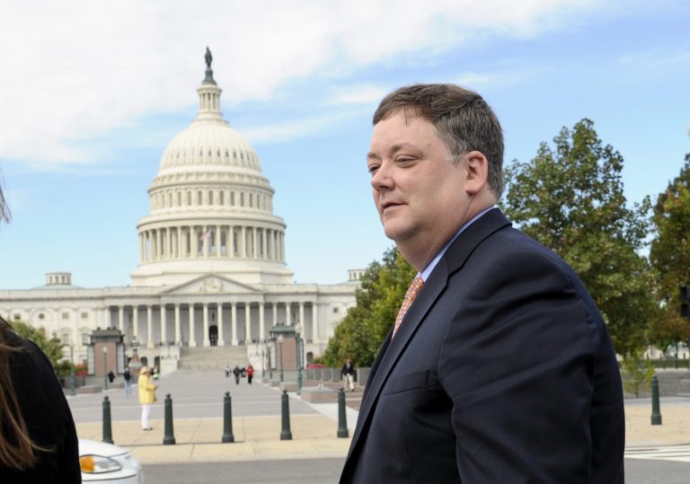 Republican activist Shaun McCutcheon of Hoover, Ala., walks past the Capitol as he leaves the Supreme Court on Tuesday after the court's hearing on campaign finance. The Supreme Court is tackling a challenge to limits on contributions by the biggest individual donors to political campaigns. President ObamaÃÂ argued against lifting limits on donors, saying it would have a damaging effect on the electoral process.. (AP Photo/Susan Walsh)