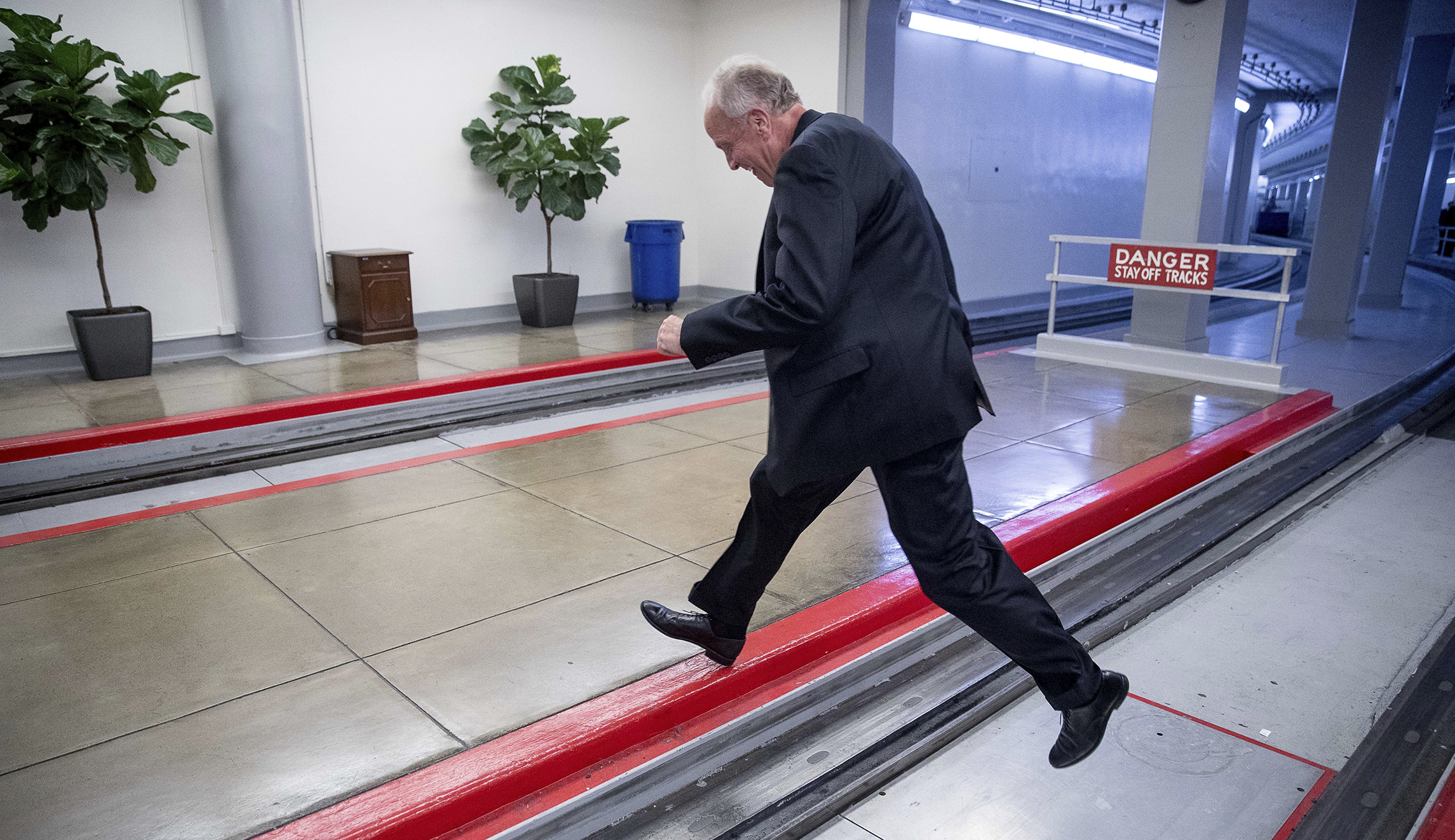 GOP Sen. Jerry Moran leaps across subway tracks to escape reporters after he sinks healthcare bill