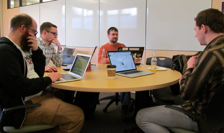In this photo taken on Tuesday, March 25, 2014, from left, Alan Palazzolo, Andrew Dahl, Bill Bushey and Jake Dalton collaborate on analyzing government data at the monthly meetup of Open Twin Cities in Minneapolis. About a dozen people attended to event at the University of Minnesota. (AP Photo/Minnesota Public Radio, Curtis Gilbert)