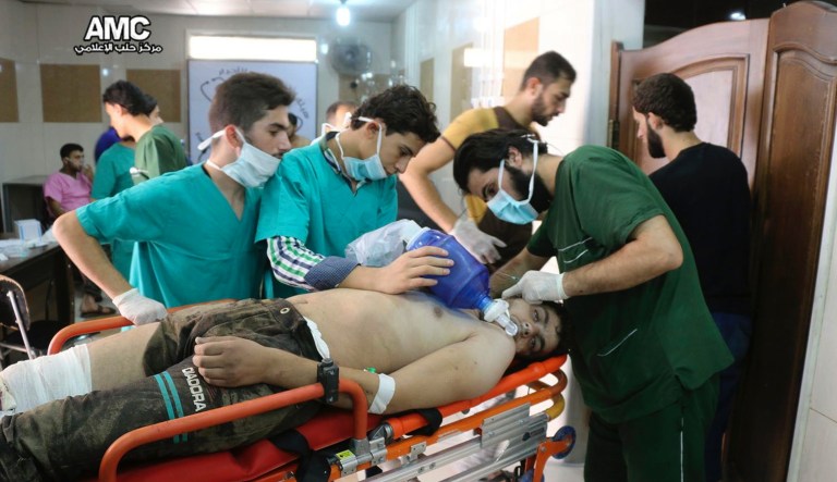 ADVANCE TO GO WITH STORY WORST ATROCITIES BY PHILIP ISSA: FILE - In this Tuesday, Sept. 6, 2016 filephoto, provided by the Syrian anti-government activist group Aleppo Media Center (AMC), shows medical staff treating a man suffering from breathing difficulties inside a hospital in Aleppo, Syria.                         