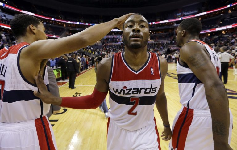 Alex Brandon/AP
Wizards guard John Wall celebrates with guard Garrett Temple and forward Martell Webster after Washington beat Milwaukee 106-93 on Wednesday.