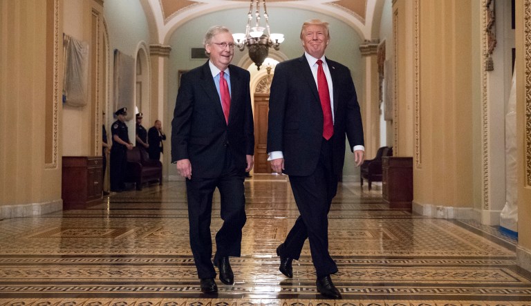 President Donald Trump, escorted by Senate Majority Leader Mitch McConnell, R-Ky., arrives on Capitol Hill to have lunch with Senate Republicans and push for his tax reform agenda, in Washington, Tuesday, Oct. 24, 2017. (AP Photo/J. Scott Applewhite)