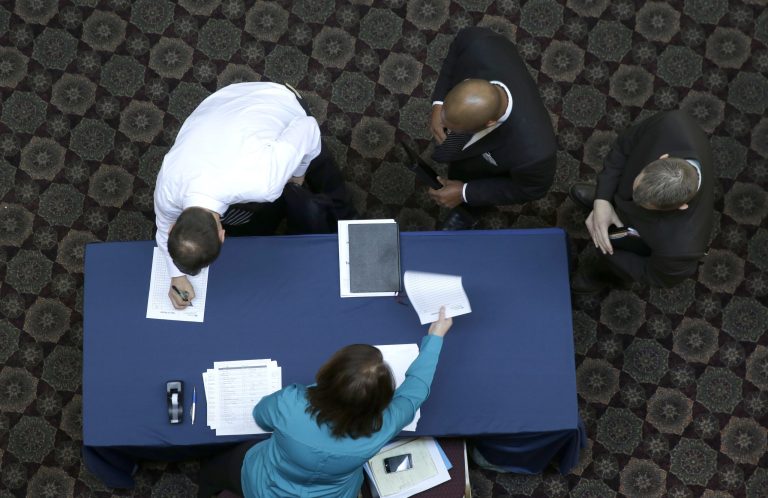 Job seekers sign in before meeting prospective employers during a career fair at a hotel in Dallas. Payroll processor ADP reports on job growth at U.S. companies in February, on Wednesday, March 5, 2014.  (AP Photo/LM Otero, File)