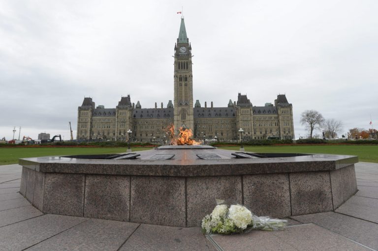 A bouquet of flowers lay at the eternal flame on Parliament Hill in Ottawa on Thursday, Oct. 23, 2014. (AP Photo/The Canadian Press, Adrian Wyld)