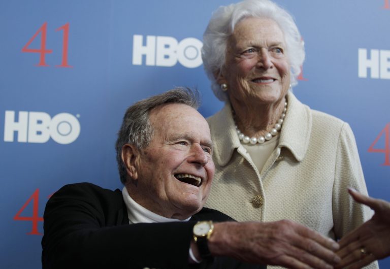   FILE - In a Tuesday, June 12, 2012 file photo, former President George H.W. Bush, and his wife, former first lady Barbara Bush, arrive for the premiere of HBO's new documentary on his life near the family compound in Kennebunkport, Maine. Bush spokesman Jim McGrath said Wednesday, Dec. 26. 2012 that doctors at the Houston hospital where Bush has been treated for a month remain âcautiously optimisticâ that he will recover. Still, no discharge date has been set, and McGrath says that doctors are being cautious because at Bushâs age âsometimes issues crop up that are beyond anybodyâs ability to discern or foretell.â(AP Photo/Charles Krupa, File)  