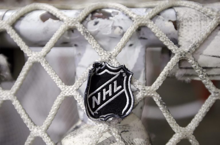   FILE - In this file photo taken Sept. 17, 2012, the NHL logo is seen on a goal at a Nashville Predators practice rink in Nashville, Tenn. The NHL eliminated 16 more days from the regular-season schedule Monday, Dec. 10, 2012, and if a deal with the players' association isn't reached soon the whole season could be lost. The league wiped out all games through Dec. 30 in its latest round of cancellations. Negotiations between the league and the players' association broke off last week, but NHL deputy commissioner Bill Daly said Sunday the sides are trying to restart talks this week. (AP Photo/Mark Humphrey, file)  