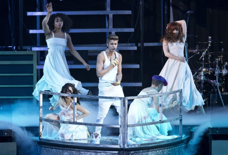 FILE - In this Monday, March 4, 2013 file photo, Canadian singer Justin Bieber performs at the O2 Arena in east London. Bieber is recovering after fainting backstage at a concert in London. A spokeswoman for Bieber said Thursday, March 7, 2013, that the 19-year-old pop star was given oxygen and took a 20-minute reprieve after fainting backstage at London's O2 Arena. (Photo by Joel Ryan/Invision/AP, File)