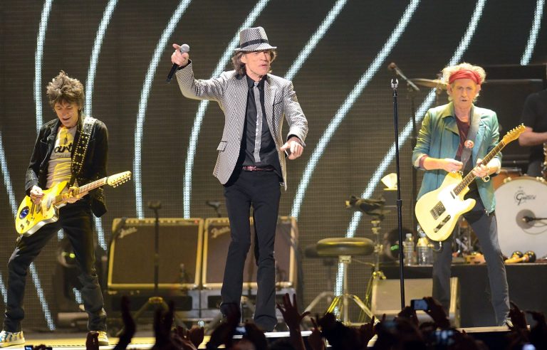   In this Saturday, Dec. 15, 2012 file photo, singer Mick Jagger, center, guitarists Ronnie Wood, left, and Keith Richards, of The Rolling Stones perform live at the Prudential Center in Newark, N.J. (Photo by Evan Agostini/Invision/AP, File)  