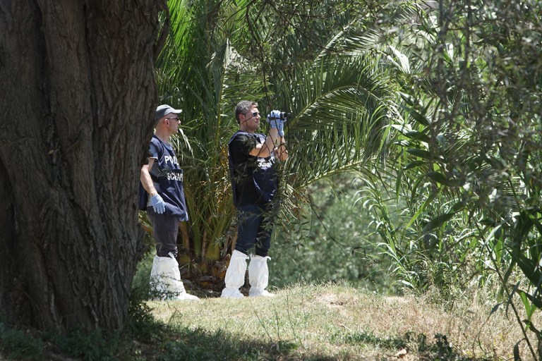 Forensic police scan the banks of the Tiber River in Rome where the body of a young man was found Monday. Italian authorities on Monday were investigating the disappearance of a Wisconsin student in Rome a day after he arrived in the Italian capital. (AP Photo/Andrew Medichini)