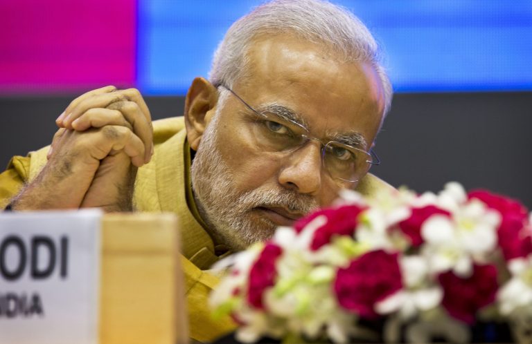 Indian Prime Minister Narendra Modi sits during the launche his 'Make in India' initiative, prior to his scheduled departure to the U.S.  in New Delhi, India, Thursday, Sept. 25, 2014. Modi's five-day trip starting Friday is tightly packed: He will be meeting Obama and a slew of top American officials, addressing the U.N. General Assembly, interacting with the heads of major U.S. companies and influential Indian-Americans. (AP Photo/Saurabh Das)