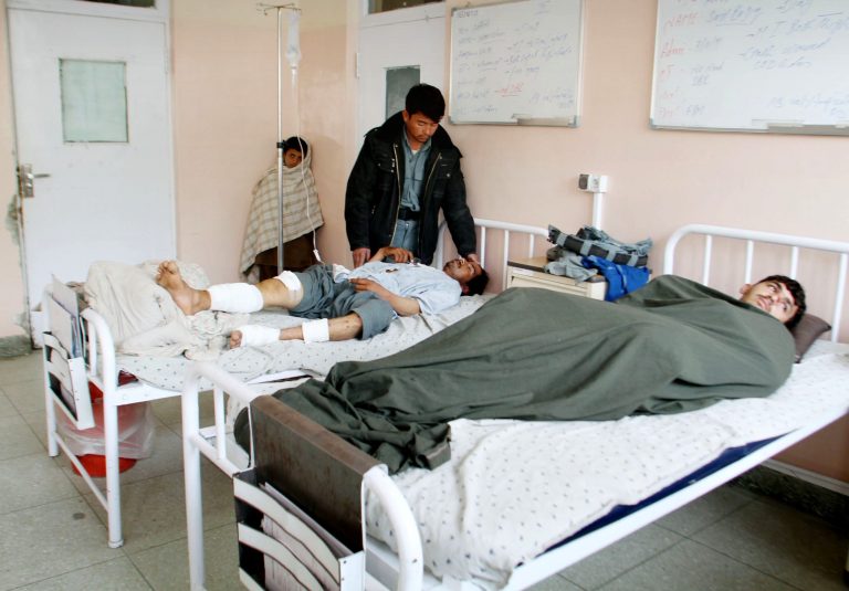 Victims of a roadside bomb lie on hospital beds after their truck was hit by roadside bomb in Kandahar, south of Kabul, Afghanistan, Sunday, Jan. 27, 2013. A police truck packed with officers and detainees struck a roadside bomb in southern Afghanistan's largest city, killing several of those aboard, officials said Sunday. (AP Photo/Allauddin Khan)