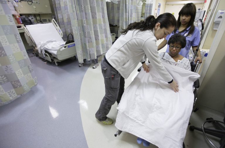 FILE - In this file photo taken, Nov. 30, 2010, nurses at University of Chicago Medical Center in Chicago prepare patient Paula Ellis to be transported for tests. The U.S. job market has steadily improved by pretty much every gauge except the one Americans probably care about most: Pay. Wages are up just 1.3 percent for employees in education and health care. (AP Photo/M. Spencer Green)