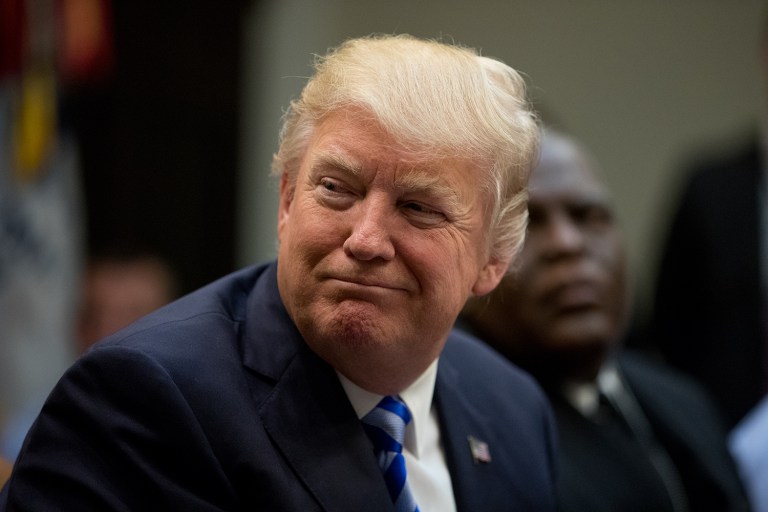 As the American Health Care Act was going up in flames, Trump seemed standoffish. (AP Photo/Andrew Harnik)