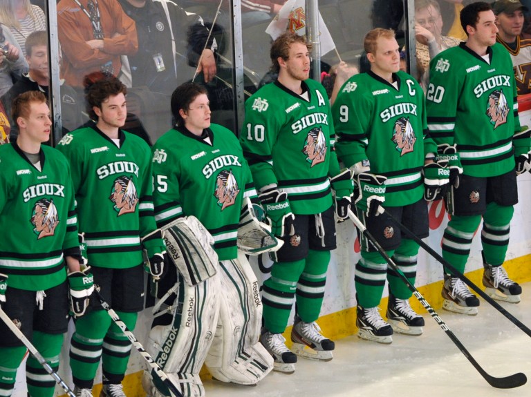   FILE - This March 16, 2012, file photo shows North Dakota hockey players wearing Fighting Sioux logo jerseys that were replaced by new jerseys during WCHA Final Five Championships in St. Paul, Minn. The years-long battle over the University of North Dakotaâs Fighting Sioux moniker is in votersâ hands Tuesday, June 12, 2012, as a measure to nix the nickname hits the ballot. (AP Photo/Jim Mone, File)  