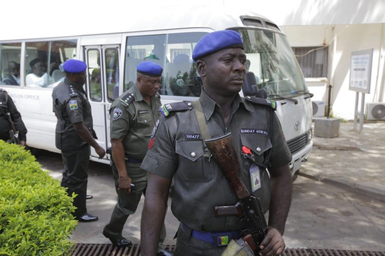 Security men stand guard in front of a bus conveying All progressives Congress opposition governors  after visiting victims of  at the  Accident and Emergency unit of Asokoro hospital where injured people from Monday's explosion at a bus station are receiving treatment in Abuja, Nigeria, Wednesday, April 16, 2014. Scores of peopledied in the  the blast that destroyed more than 30 vehicles and caused secondary explosions as their fuel tanks exploded and burned. The Monday attack just miles from Nigeria's seat of government increases doubts about the military's ability to contain an Islamic uprising that is dividing the country on religious lines as never before. (AP Photo/ Sunday Alamba)