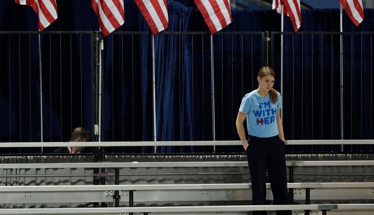 A Clinton supporter stands alone in the bleachers after Democratic presidential nominee Hillary Clinton's election night rally was canceled at the Jacob Javits Center in New York, Wednesday, Nov. 9, 2016. (AP Photo/Patrick Semansky)