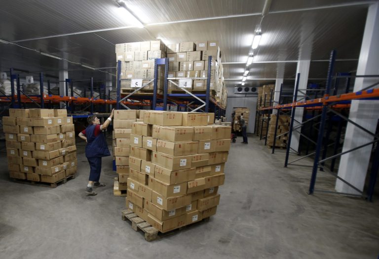 A worker inspects aid delivered from Russia in the town of Luhansk, eastern Ukraine, Saturday, Sept. 13, 2014. More than 200 Russian trucks carrying humanitarian supplies entered into Ukraine with supplies for the city of Luhansk, which has for weeks been cut off from electricity and water supplies. (AP Photo/Darko Vojinovic)