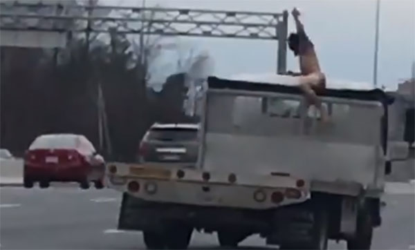 A man, identified by police as 32-year-old Jose Gonzalez Flores, was caught on video in Fairfax County, Va., on Tuesday jumping onto a moving truck and stabbing the truck with a knife. (Screen shot)