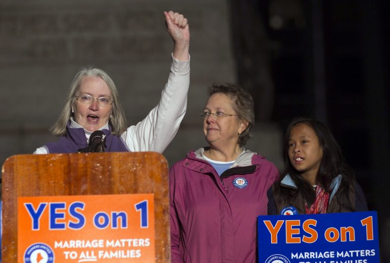   FILE - In this Nov. 1, 2012 file photo, Sarah Dowling, left, speaks at a gay marriage rally, accompanied by her partner of 18 years, Linda Wolfe, and their daughter, Maya Dowling-Wolfe, in Portland, Maine. Dowling and Wolfe plan to marry after Maine passed a law allowing same-sex marriage, which takes effect at 12:01 a.m., Saturday, Dec. 29, 2012. (AP Photo/Robert F. Bukaty, File)  