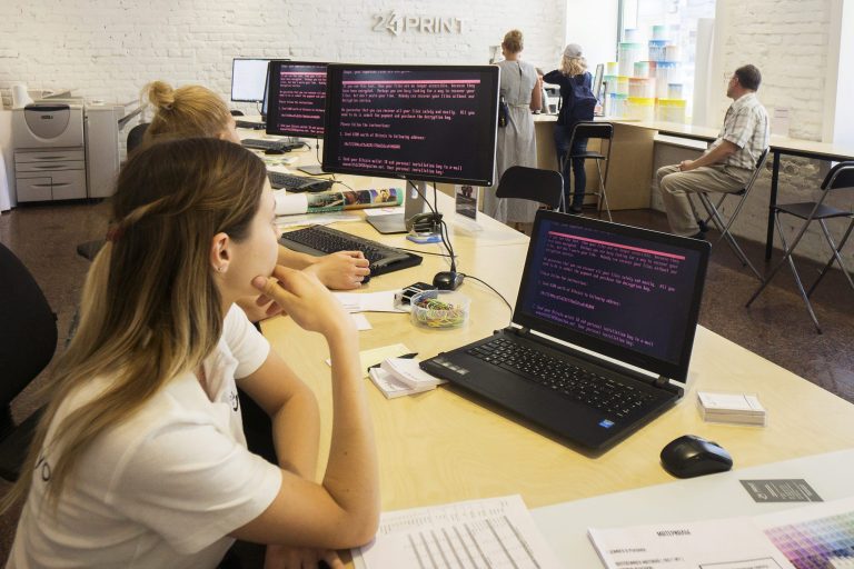 Employees read a ransomware demand for the payment of $300 worth of bitcoin on company computers infected by the 'Petya' software virus inside a retail store in Kiev, Ukraine, on June 28. (Vincent Mundy/Bloomberg)