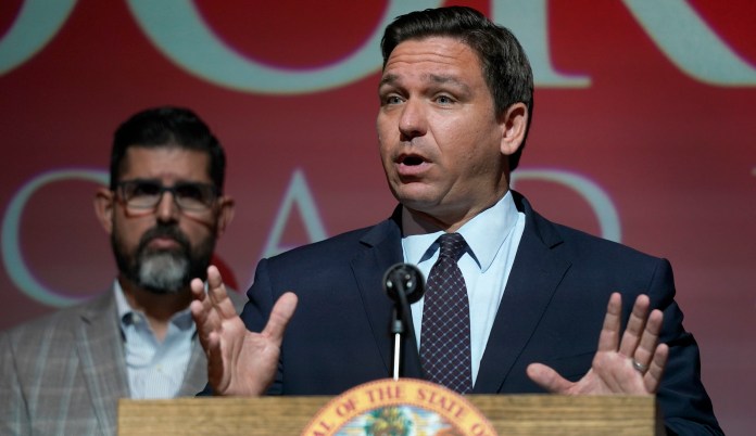 Florida Gov. Ron DeSantis, gestures as he speaks on Sept. 14, 2021, at the Doral Academy Preparatory School in Doral, Florida. Behind the governor is state Sen. Manny Diaz Jr.