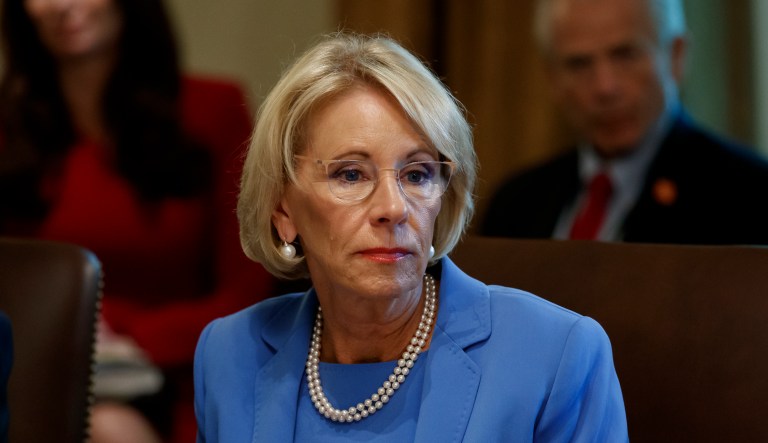 FILE - In this July 16, 2019, file photo, Education Secretary Betsy DeVos listens during a Cabinet meeting in the Cabinet Room of the White House in Washington. The Trump administration is threatening to cut grant funding to a Middle East studies program at the University of North Carolina and Duke University, saying itâs misusing federal funding to advance âideological prioritiesâ and unfairly promotes âthe positive aspects of Islamâ but not Christianity or Judaism. 