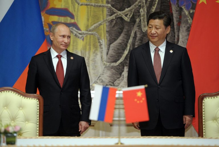 In this May 21, 2014, photo, Russia's President Vladimir Putin, and China's President Xi Jinping, right, smile during signing ceremony in Shanghai, China. China signed a long-awaited, 30-year deal Wednesday to buy Russian natural gas worth some $400 billion in a financial and diplomatic boost to diplomatically isolated President Vladimir Putin. The Obama administration is playing down an increasingly warm relationship between its main global rivals, China and Russia, that it may have inadvertently encouraged. 