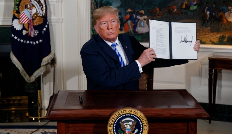President Donald Trump signs a Presidential Memorandum on the Iran nuclear deal from the Diplomatic Reception Room of the White House, Tuesday, May 8, 2018, in Washington.