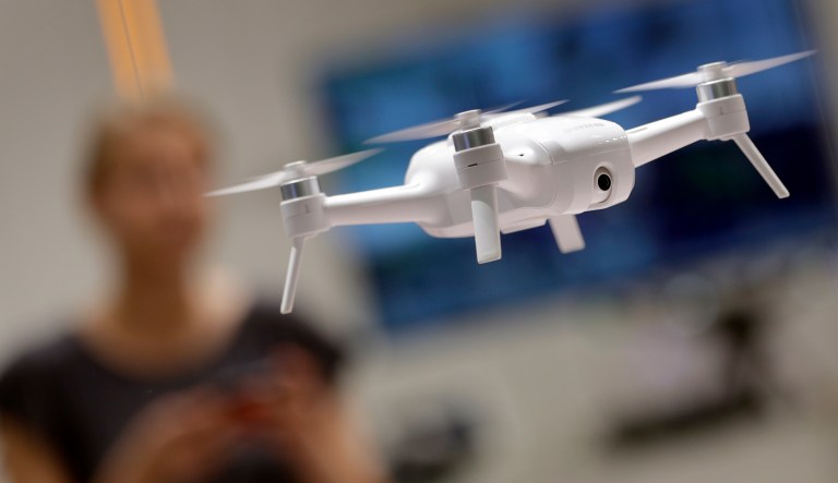 FILE - In this Aug. 31, 2017 file photo Melanie Richter controls the Yuneec selfie drone 'Breeze 4K' with a smartphone at the IFA 2017 tech fair in Berlin, Germany.