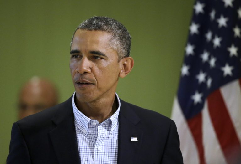 President Obama approaches a podium before facing reporters Thursday in Edgartown, Mass., to speak about developments in Iraq and the police shooting of 18-year-old Michael Brown, in Ferguson, Missouri.(AP Photo/Steven Senne)