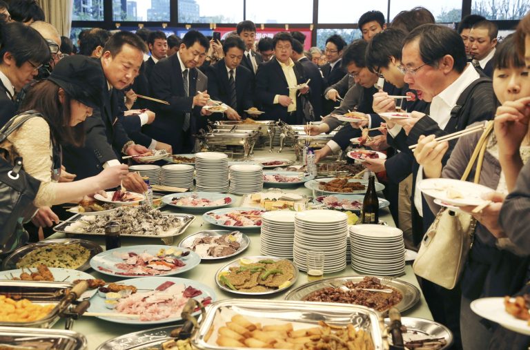 Supporters of whaling eat meat of whale during a meeting of the 26th support whaling event in Tokyo, Tuesday, April 15, 2014. (AP Photo/Koji Sasahara)