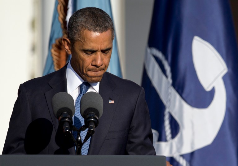   President Barack Obama pauses as he speaks during a memorial service for the victims of the Washington Navy Yard shooting at Marine Barracks Washington, Sunday, Sept. 22, 2013, in Washington. A gunman killed 12 people in the Navy Yard on Monday, Sept. 16, 2013, before being fatally shot in a gun battle with law enforcement. (AP Photo/Carolyn Kaster)  