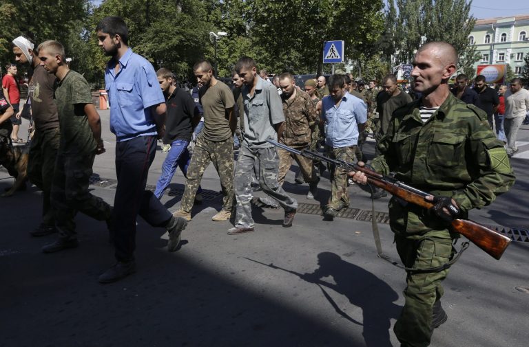 Pro-Russian rebels escorting captured Ukrainian army prisoners on central square in Donetsk, eastern Ukraine, Sunday, Aug. 24, 2014. Ukraine has retaken control of much of its eastern territory bordering Russia in the last few weeks, but fierce fighting for the rebel-held cities of Donetsk and Luhansk persists. (AP Photo/Sergei Grits)