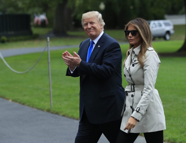 President Donald Trump with first lady Melania Trump smiles at reporters as they arrive back to White House in Washington, Friday, Oct. 13, 2017, from a visit to the United States Secret Service James J. Rowley Training Center in Beltsville, Md. (AP Photo/Manuel Balce Ceneta)