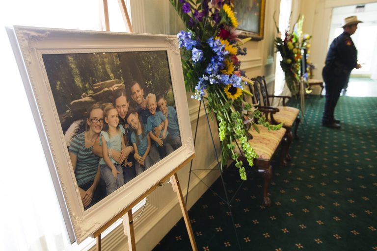 A family portrait of the Stephen and Katie Stay family is on display before visitation at Klein Funeral Home Tuesday, July 15, 2014, in Houston. Ron Lee Haskell has been charged in the shooting deaths of the six members of the Stay Family. (AP Photo/Houston Chronicle, Brett Coomer)