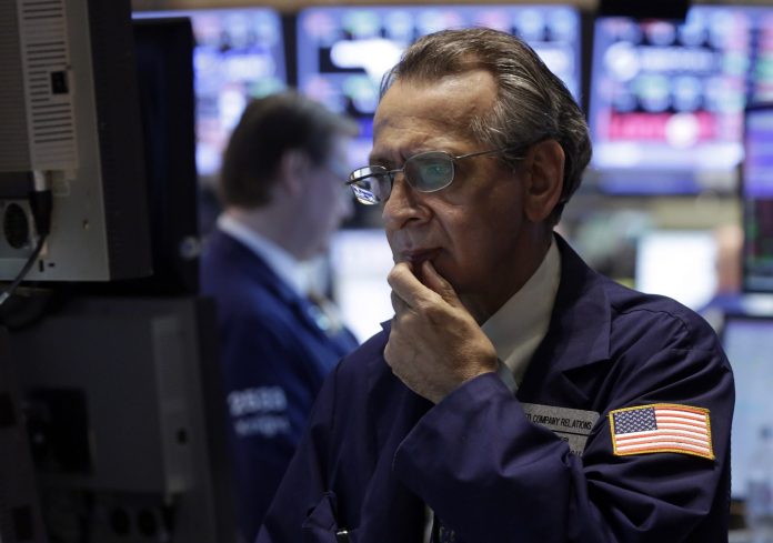 AP/Richard Drew Specialist Joseph Quaglieri looks at a monitor as he works on the floor of the New York Stock Exchange on Thursday.