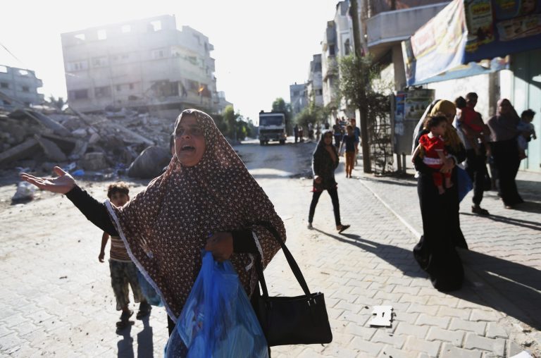 Palestinians flee their homes Wednesday in the Shajaiyeh neighborhood of Gaza City after Israel had airdropped leaflets warning people to leave the area. Alongside the air strikes, Israel also ordered tens of thousands of residents of the northern town of Beit Lahiya and the Zeitoun and Shijaiyah neighborhoods of Gaza City, all near the border with Israel, to evacuate their homes. The warnings were delivered in automated phone calls, text messages and leaflets.(AP Photo/Lefteris Pitarakis)