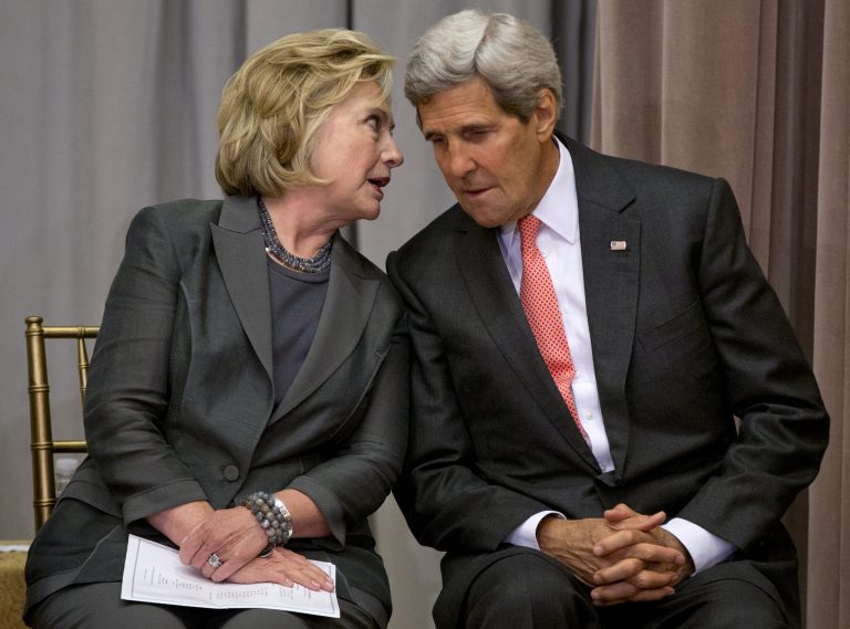Secretary of State John Kerry speaks with former Secretary of State Hillary Rodham Clinton during the groundbreaking ceremony for the U.S. Diplomacy Center, Wednesday, Sept. 3, 2014, at the State Department in Washington. (AP Photo/Carolyn Kaster)