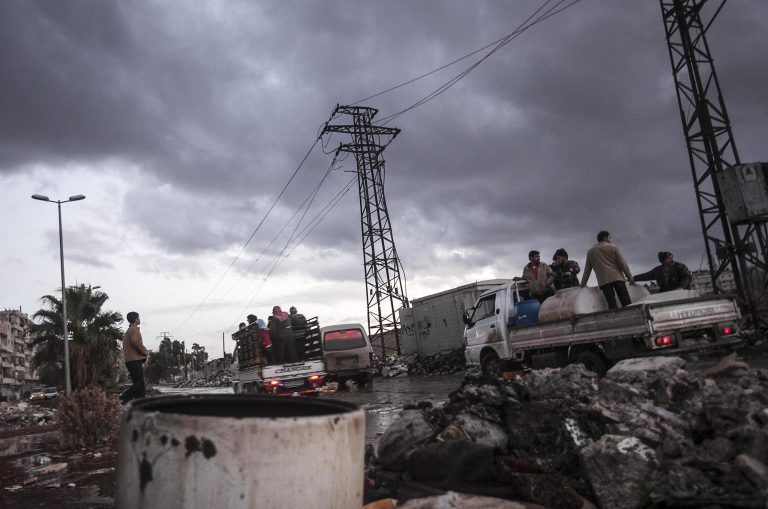   Syrians stand on trucks at a street in Aleppo, Syria, Tuesday, Dec. 4, 2012. Temperatures dropped to 16 degrees Celsius (60.8 Fahrenheit) in Aleppo. (AP Photo/Narciso Contreras)  