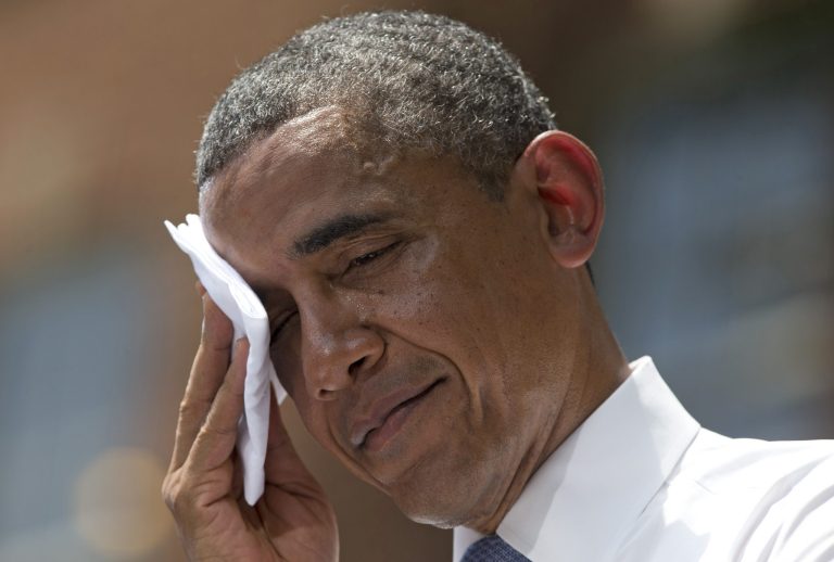 FILE - In this June 25, 2013 file photo, President Barack Obama wipes sweat from his head during a speech on climate change, at Georgetown University in Washington. President Barack Obama is sticking to a fossil-fuel dependent energy policy, delivering a blow to a monthslong, behind-the-scenes effort by nearly every major environmental group to convince the White House that the policy is at odds with his goals on global warming. (AP Photo/Evan Vucci, File)