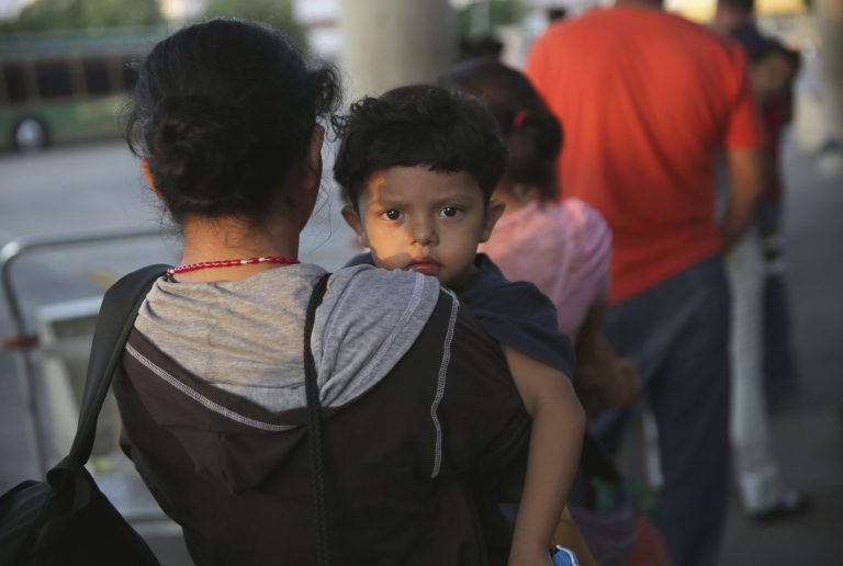 Salvadorian immigrants just released from U.S. Border Patrol detention wait at the Greyhound bus station for their journey to Houston on July 25, 2014 in McAllen, Texas. (Photo by John Moore/Getty Images)
