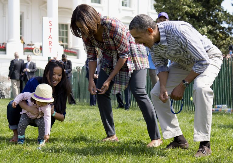 President Barack Obama and first lady Michelle Obama cheer a little egg roller as they host the White House Easter Egg Roll on the South Lawn of the White House is Washington, Monday, April 21, 2014. Thousands of children gathered at the White House for the annual Easter Egg Roll. President Barack Obama and first lady Michelle Obama kicked off the festivities on the White House South Lawn. This year's event features live music, cooking stations, storytelling, and of course, some Easter egg rolling.  (AP Photo/Carolyn Kaster)