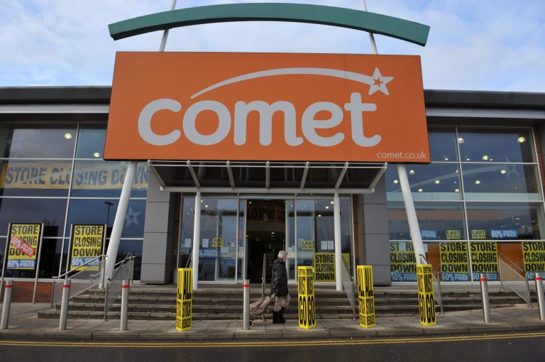   A pedestrian walks outside a Comet store prior to closing in Basildon, Essex, Tuesday, Dec. 18. 2012. British electrical retailer Comet has opened its doors for the final time after nearly 80 years. The last 49 stores of what was a 235-strong chain are closing Tuesday after Comet's new owners failed to deal with a sour British economy and the online shopping revolution. (AP Photo/PA, Nick Ansell) UNITED KINGDOM OUT, NO SALES, NO ARCHIVE  