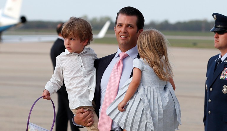 Donald Trump Jr., carries his daughter Chloe Trump, right, and Spencer Trump, as they step off Air Force One. (AP Photo/Alex Brandon)