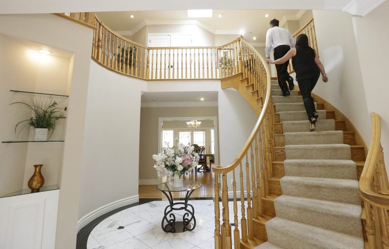 A realtor walks with a potential buyer at a home for sale. The National Association of Realtors releases existing home sales for June on Wednesday. (AP Photo/Jeff Chiu)
