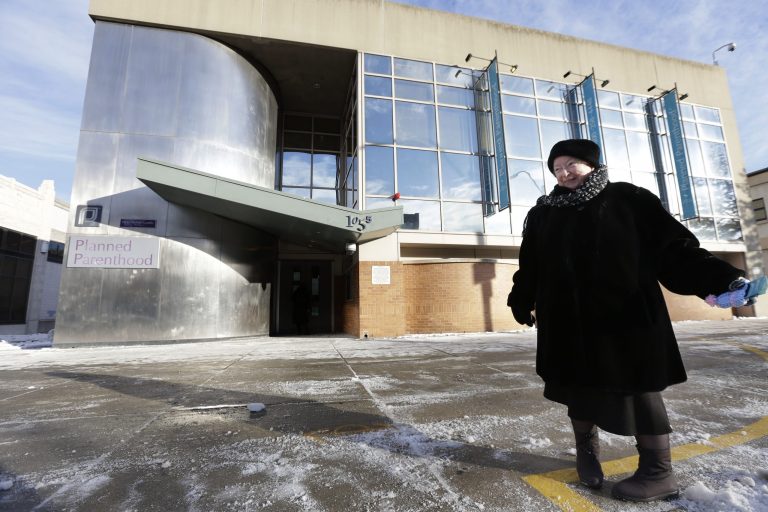 This photo taken Dec. 17, 2013 shows anti-abortion protester Eleanor McCullen, of Boston, standing at the painted edge of a buffer zone outside a Planned Parenthood location in Boston. The regulation of protests outside abortion clinics returns to the Supreme Court for the first time since 2000 to find the justices seemingly more protective of speech and less committed to abortion rights. That combination could prove difficult to overcome for the state of Massachusetts as it seeks to defend a law, in arguments at the high court on Jan. 15, that prohibits abortion protests any closer than 35 feet from the entrance to clinics. (AP Photo/Steven Senne)